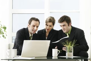 Three professionals at laptop

